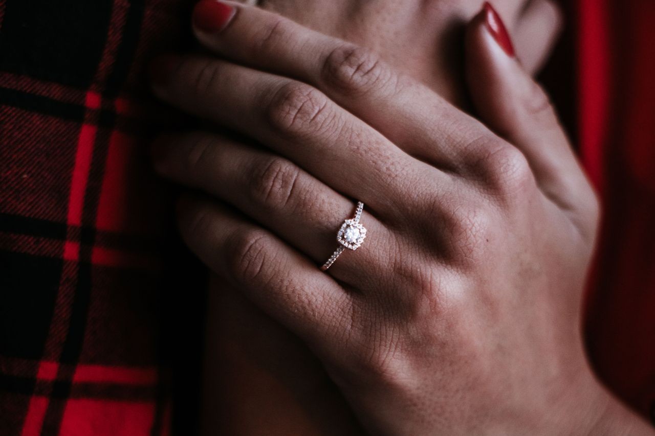 Mysterious lady wearing an extraordinary engagement ring with a square halo setting and a pave sidestone accent Mysterious lady wearing an extraordinary engagement ring with a square halo setting and a pave sidestone accent